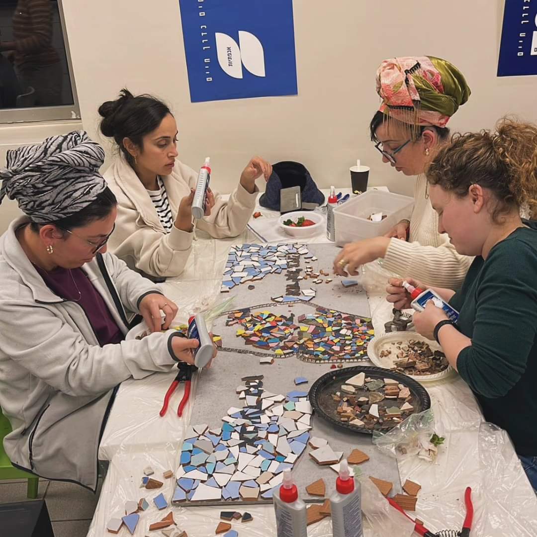 Women working on mosaic for Shlomit