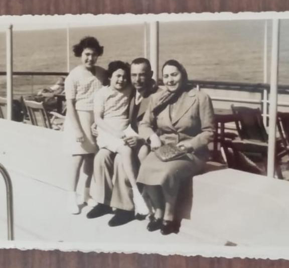 Omy with her sister and parents on a boat to Palestine