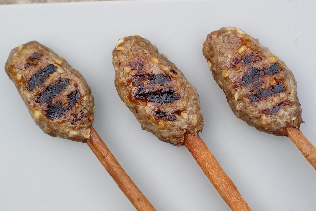 Beef and date molasses kebabs on cinnamon sticks